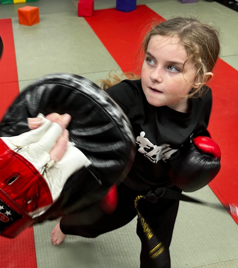 Young girl practicing martial arts at Kicx Academy Gloucester—developing focus, skill, and confidence