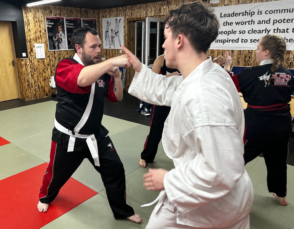 Adult martial arts class at Kicx Academy Gloucester—adults training for fitness, self-defense, stress relief, and personal development