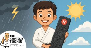 Smiling child in karate uniform holding a remote with pause button, symbolising emotional control at Kicx Academy