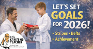 Martial arts instructor presenting a red belt to a white belt child, teaching goal setting, focus and confidence for kids in 2026