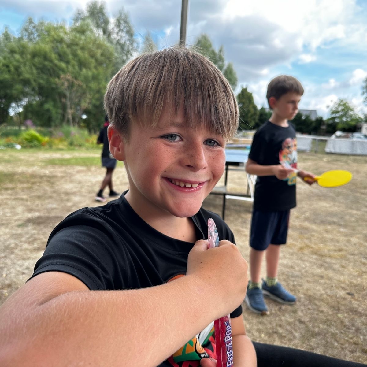 Child giving a thumbs up while enjoying Kicx Summer Camp in Gloucester.